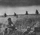 Romanian motorcyclist on a break by the side of the road. Note the white scarf around his arm, worn so that the German allies won't confuse him with a Soviet soldier