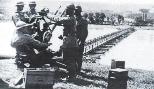 Romanian AA gun guarding a bridge over the river Dniester; note the gunners' Adrian model 1916 helmets