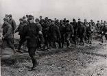 Soviet prisoners escorted by Romanian soldiers. Note the white bands on the left arm, used to avoid misidentification by the Germans