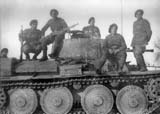 Mountain troops posing on a T-38 tank.